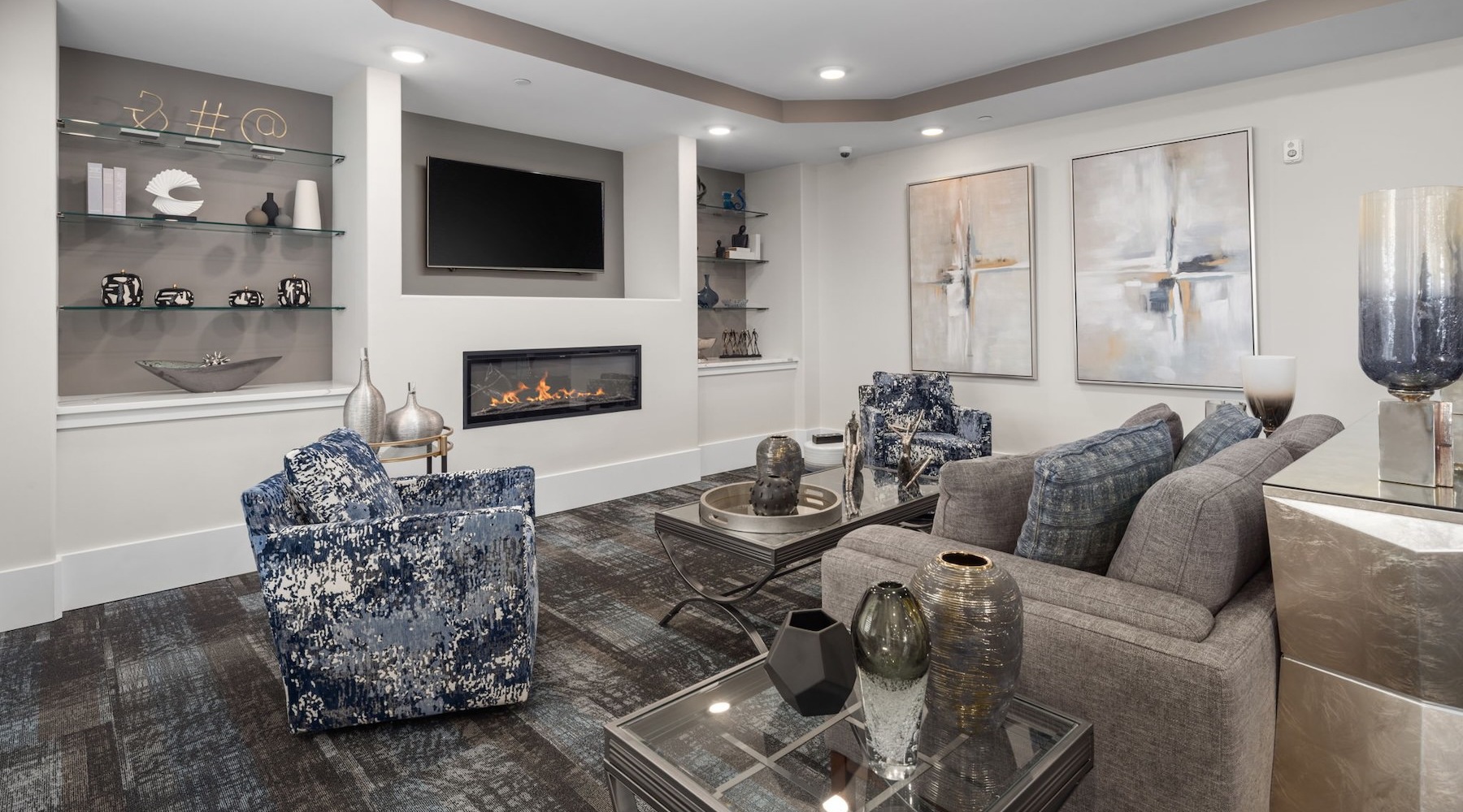 a clubroom with a tv, a couch and chairs