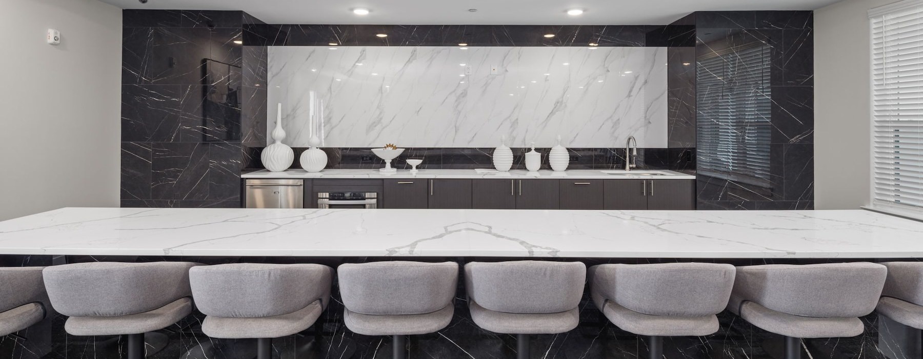 a room with a bar and chairs