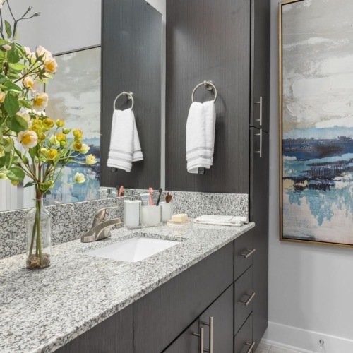 a bathroom with a vase of flowers