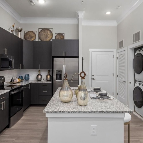 a kitchen with black cabinets