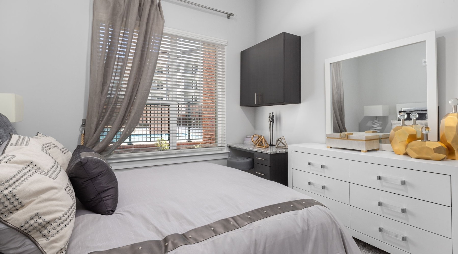 a bedroom with a bed and a dresser