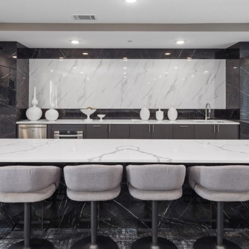 a room with a bar and chairs